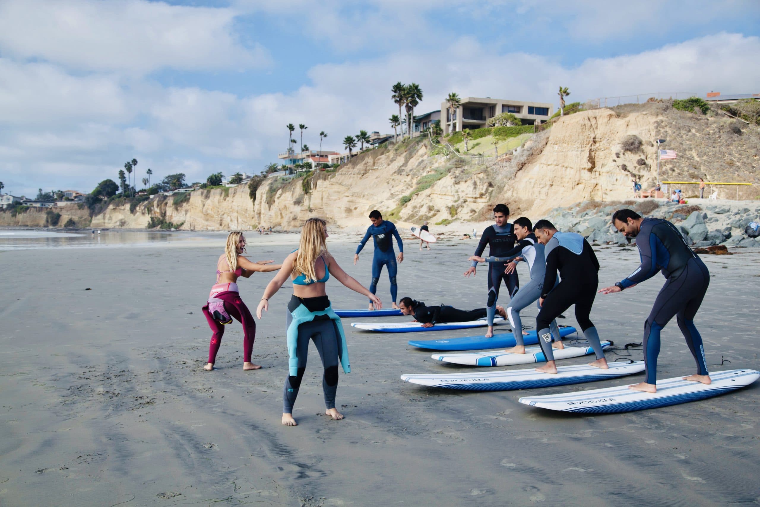 A coach guiding a student into a wave during a lesson at Tourmaline