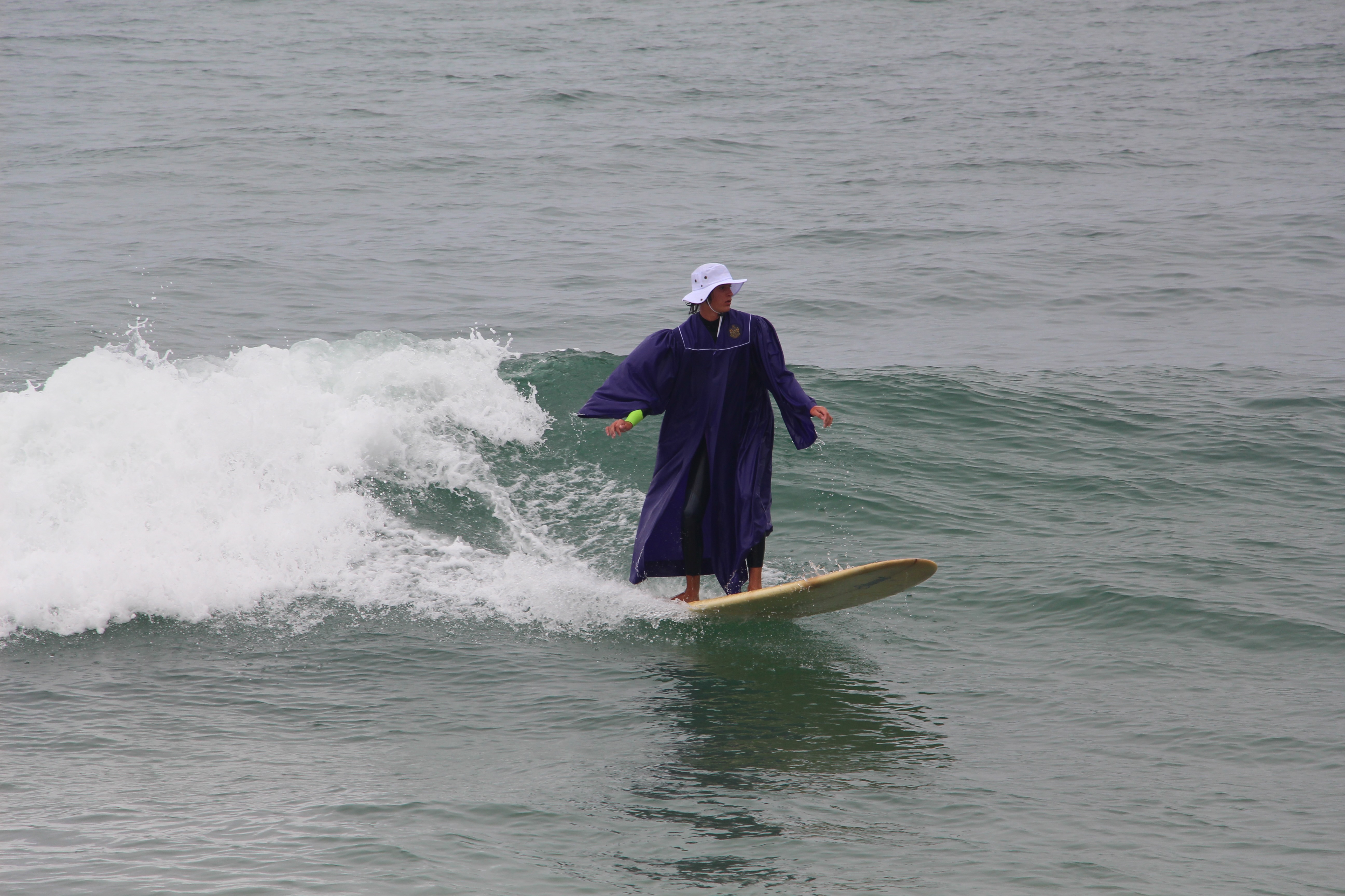 Mac, founder and instructor at Mac's Surf School, with a longboard at Pacific Beach